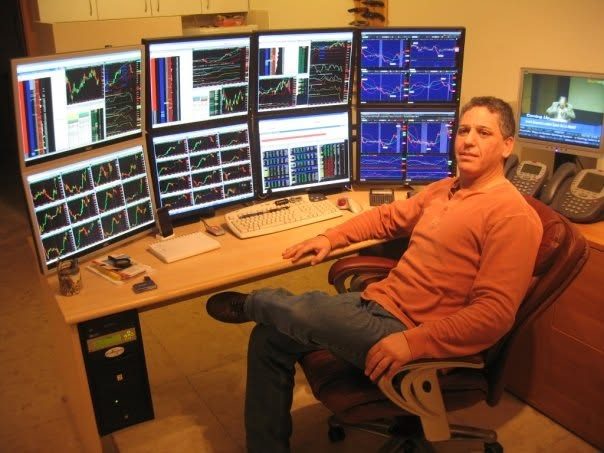 Charles Wainer at a six-monitor trading desk