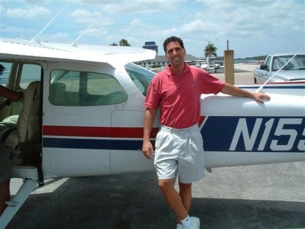Charles Wainer standing beside a Cessna